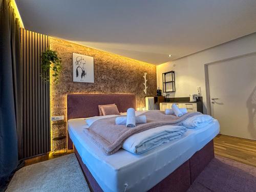 a bedroom with a large bed with towels on it at Luna Studios Zillertal in Hippach