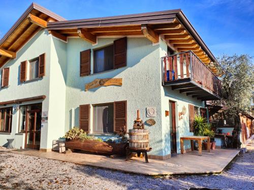 a house with a wooden deck and a balcony at Agriturismo Scuderia Castello in Gaino