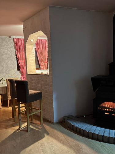 a living room with a chair and a mirror at Vila Vida in Kruševac