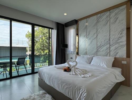 a bedroom with a bed with a swan decoration on it at Stay Tuned Pool Villa in Pattaya in Ban Huai Yai