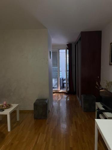 an empty living room with a wooden floor and a table at Belgrade with love in Novi Beograd