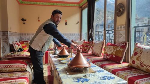 a man standing in a room with two bells at GITE DETAPE DAR AGSWAL DOUAR WANSKRA OUED IMNANE ASNI MARRAKECh in Tacheddirt