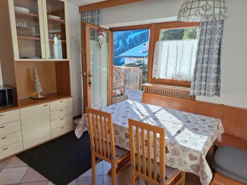 a dining room with a table and a window at Apartments Insam in Santa Cristina in Val Gardena