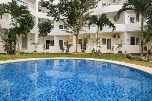 a large swimming pool in front of a building at Pool, Near Marinas, Reefs, Family Fun, 2BR Condo, Main Level in Cozumel