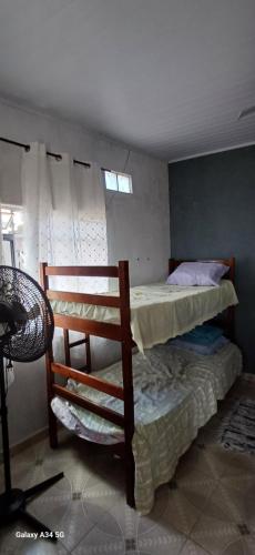 a bedroom with a bunk bed and a window at VAL's Hostel in Guarujá