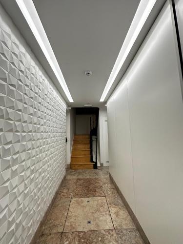 a hallway with a white brick wall and a staircase at Castle View Suites in Lisbon