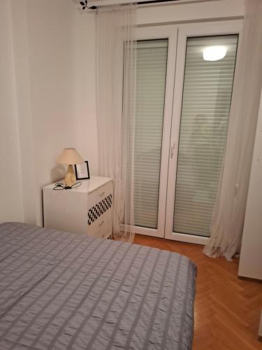 a bedroom with a bed and a window at Asami in Vrnjačka Banja