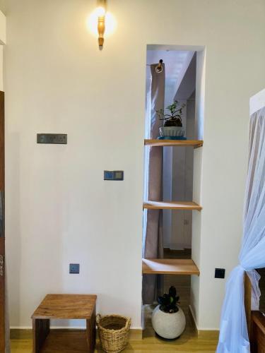 a room with wooden shelves and a table at Lisha Mawella in Tangalle