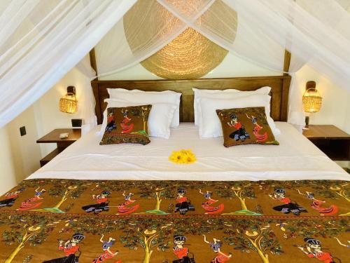 a bedroom with a bed with a white comforter at Lisha Mawella in Tangalle