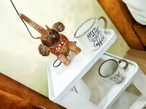 a small toy turtle sitting on a white table at Sunway Geo Avenue / Sunway Medical Centre / Pyramid / Lagoon in Petaling Jaya