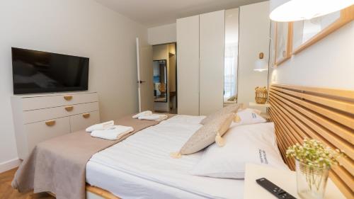 Ένα ή περισσότερα κρεβάτια σε δωμάτιο στο Apartament ODNOWA M29 basen i jacuzzi