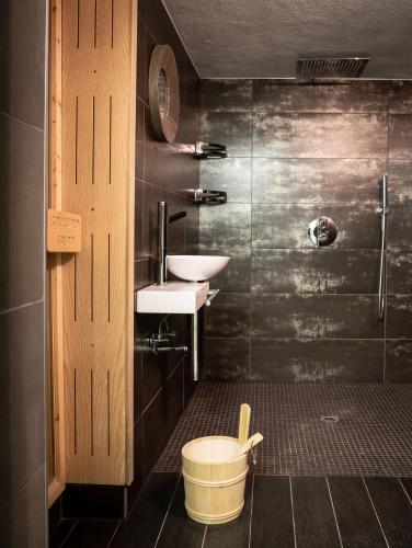 a bathroom with a toilet and a sink and a shower at Haus Wanderlust in Saint-Vith