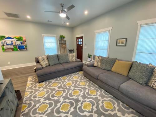 a living room with two couches and a rug at Vacation house in Galveston