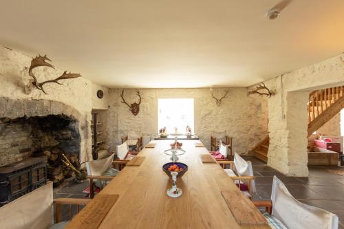 a large room with a long table and chairs at The Coach House at Ballinderry Park in Ballinasloe