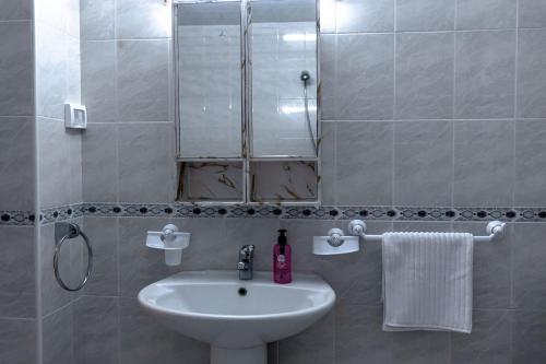 a bathroom with a sink and a mirror at CASABLU Apparte - Terrasse avec vue Sunset in Nabeul