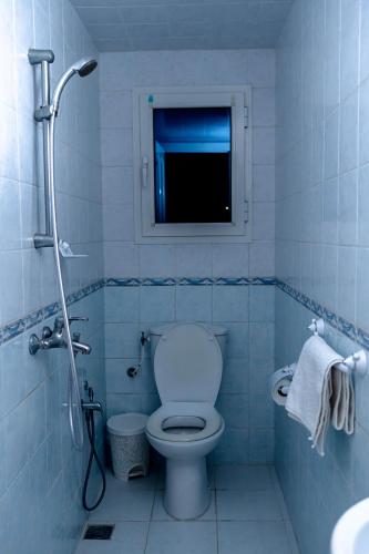 a bathroom with a toilet and a television in it at CASABLU Apparte - Terrasse avec vue Sunset in Nabeul