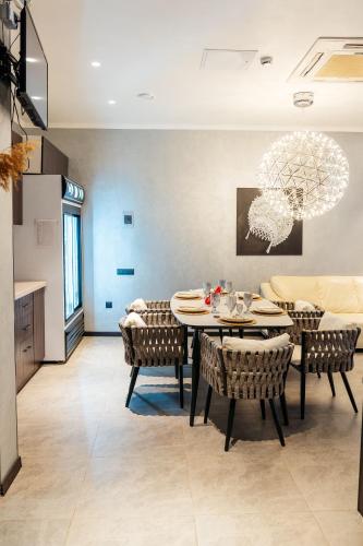 a dining room with a table and chairs at SULO VIP Spa in Atyraū