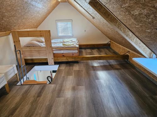 a room with a bunk bed in the attic at Baracek, Baraque in Horčápsko