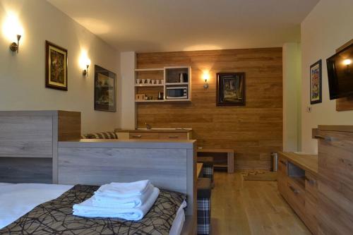 a bedroom with a bed and a counter with towels on it at Vučko Apartman 002 in Jahorina