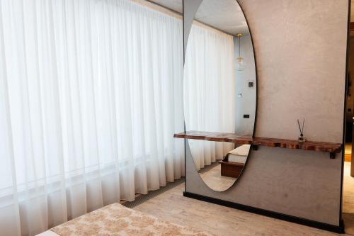 a bathroom with a mirror and a dressing table at SULO VIP Spa in Atyraū