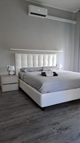 a bedroom with a large white bed in a room at Welcome home in Terni