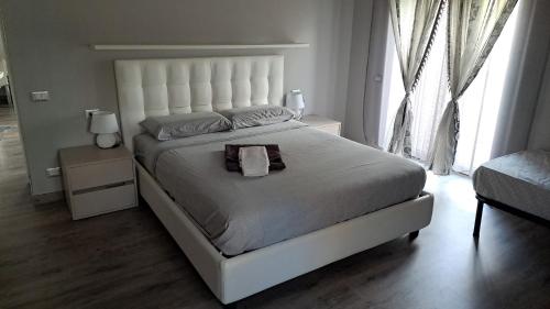 a bedroom with a large white bed with a towel on it at Welcome home in Terni