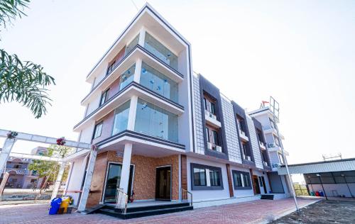 a tall building with blue windows on a street at Hotel Panna Shree in Ujjain