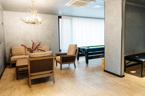 a living room with a ping pong table and a living room with a pool at SULO VIP Spa in Atyraū