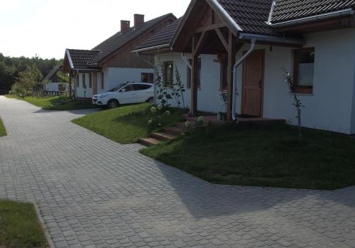 a white car parked in front of a house at Zielony-Bursztyn in Objazda-Kolonia