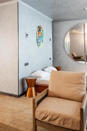 a bedroom with a bed and a mirror at SULO VIP Spa in Atyraū