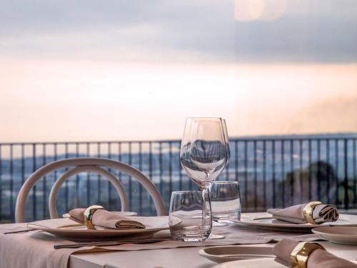a table with a wine glass on top of it at Talè Restaurant & Suite in Piedimonte Etneo