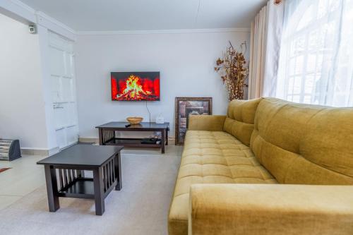 a living room with a couch and a table at Perfect 2BR Airport Layover Transit Accommodation - High Speed WiFi 30mbps in Nairobi