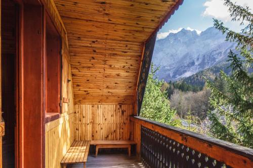a wooden room with a bench on a balcony at Chalet Romantic in Zgornje Jezersko