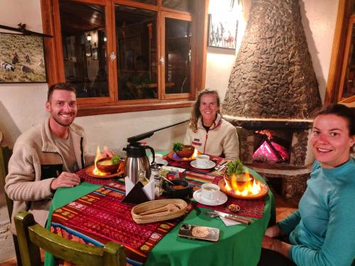 a group of people sitting at a table in a restaurant at Ruta de los volcanes in Machachi