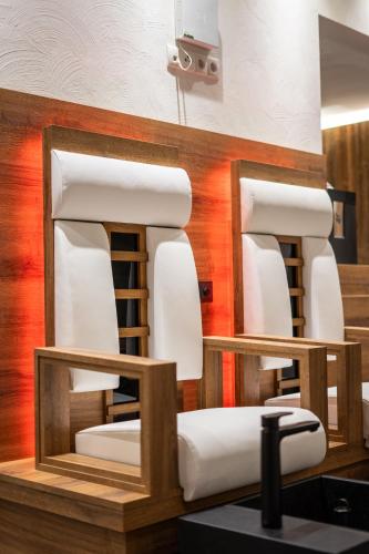two white chairs sitting on a counter in a room at Boutiquehotel - Michl in Sautens