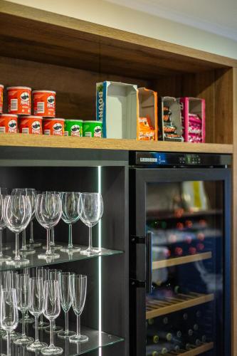 a shelf with wine glasses on top of a refrigerator at Boutiquehotel - Michl in Sautens
