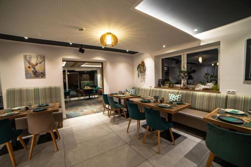 a dining room with wooden tables and chairs at Boutiquehotel - Michl in Sautens