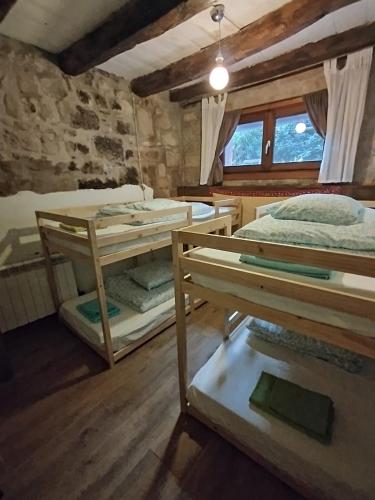 a room with three bunk beds and a window at MARILLUNA aixoplucrural in Montblanquet