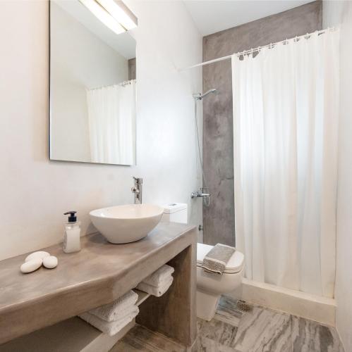 a bathroom with a sink and a toilet and a shower at Archipelagos Apartments in Parikia