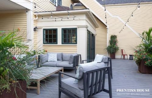 a patio with two chairs and a couch at Prentiss House by Thatch in Cambridge