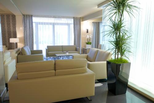 a living room with a couch and a table at Park Hotel Imperial in Limone sul Garda