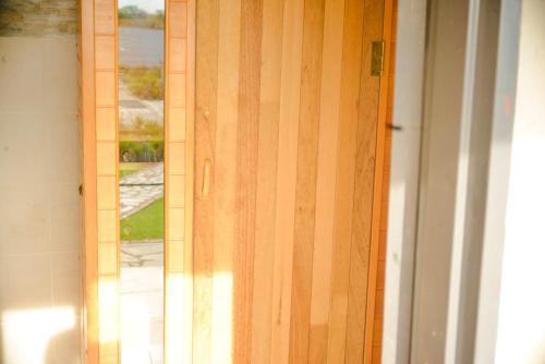 a wooden door with a window in a room at Kebo events agro &self catering apartments in Mochudi