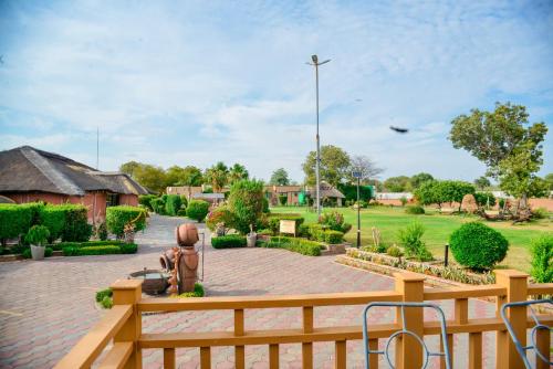 a statue sitting on a bench in a park at Kebo events agro &self catering apartments in Mochudi