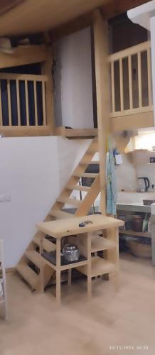 a loft bed with a staircase in a room at Maison de plain pied 2 pièces tout équipé sur jardin arboré in Laparade
