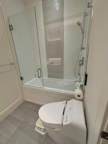 a bathroom with a white toilet and a shower at Cozy&Private Suite in Vancouver in Vancouver
