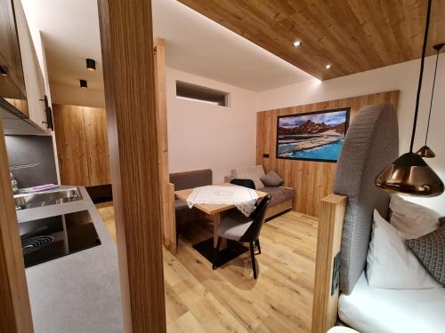 a small room with a kitchen and a small table at Hotel Mondschein in Sesto