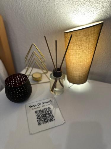 a table with two lamps and a sign on it at Apartman - Sobe Tiha Luka, Bjelašnica in Bjelašnica
