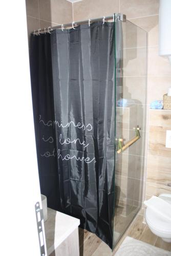 a bathroom with a shower curtain with the words remember home supreme at Silvani Kop NLux67, Milmari Apartments & Spa in Kopaonik