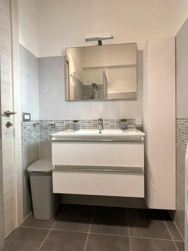 a bathroom with a sink and a mirror at Espero Ostia in Lido di Ostia
