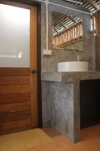 a bathroom with a sink and a mirror at Lanta Happy Hill in Ko Lanta